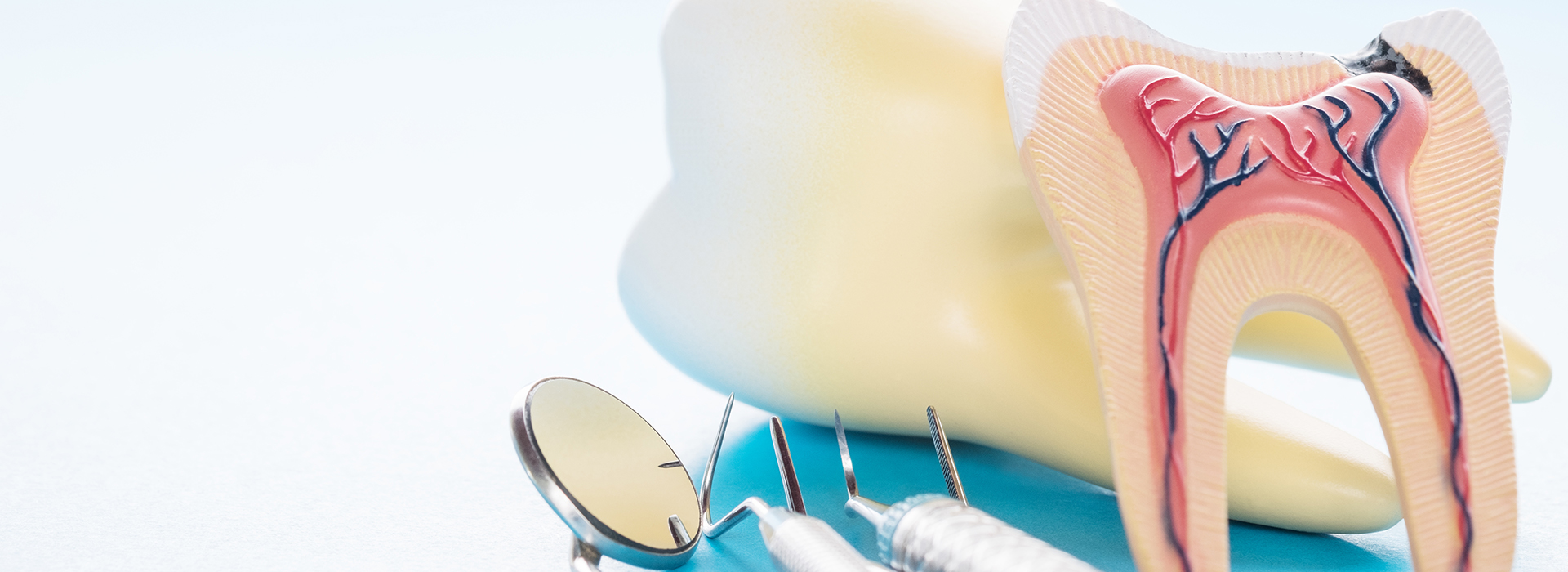 The image shows a toothbrush with bristles next to an illustration of a tooth with a cavity, placed on a white background.